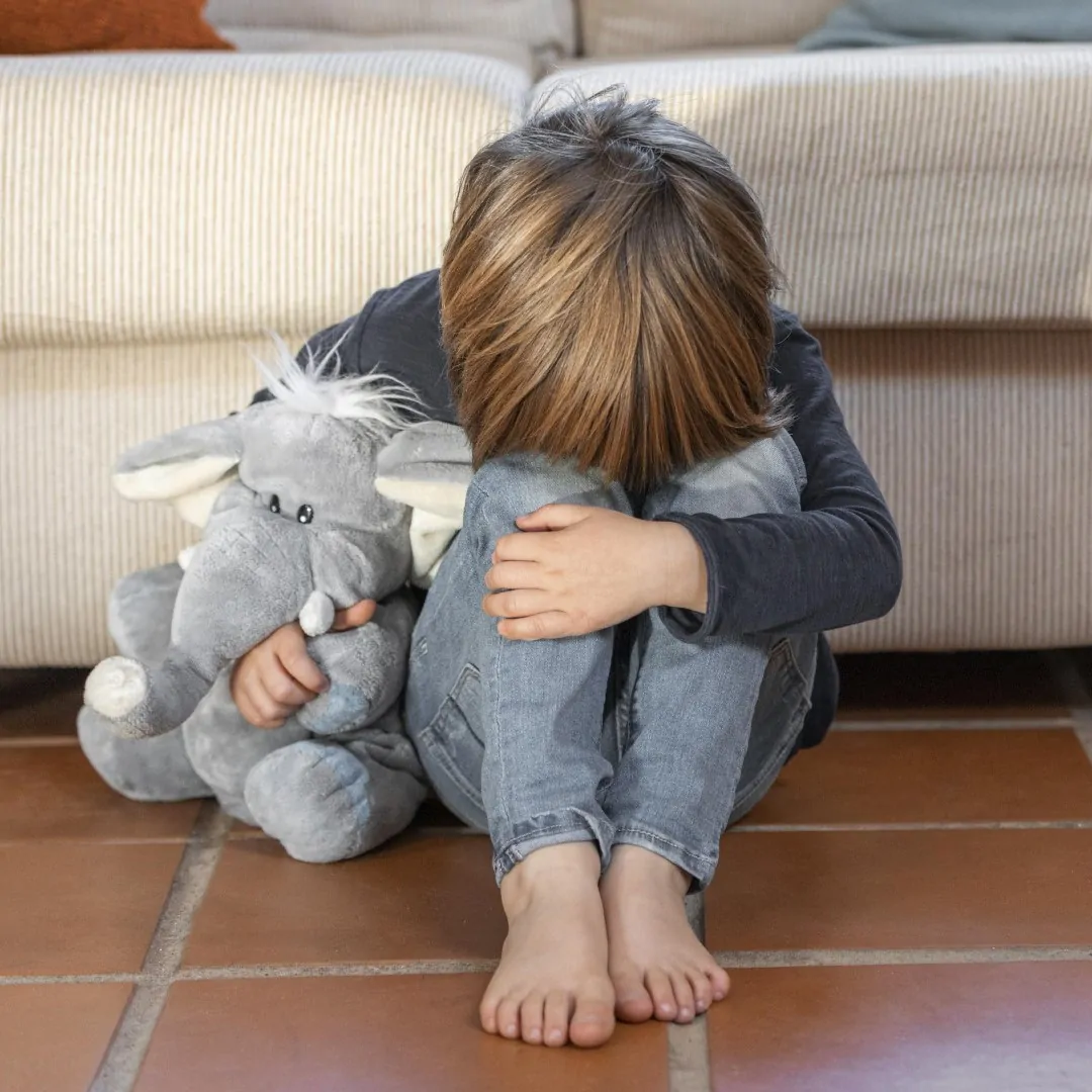 little-boy-outdoors-upset-holding-his-toy